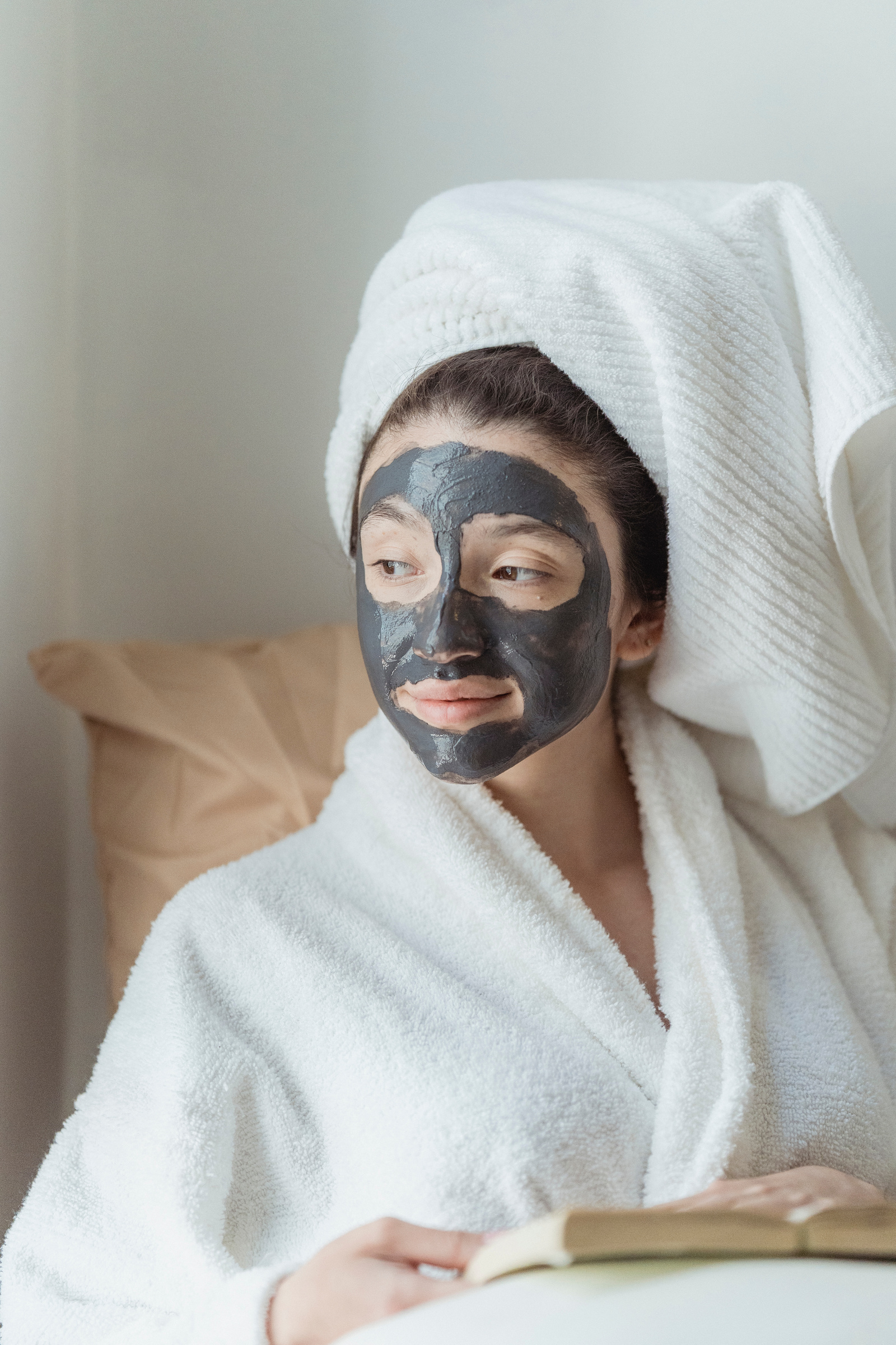 Woman in Bathrobe with Skin Care Face Mask